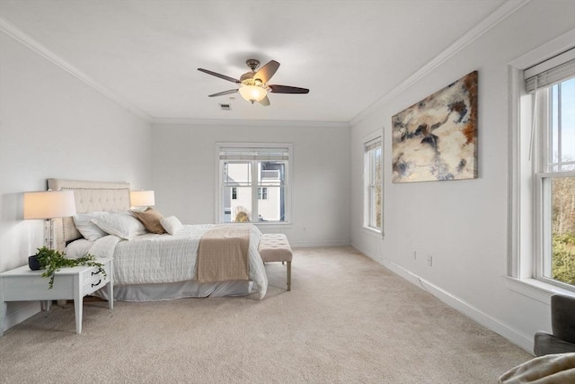 carpeted bedroom with multiple windows, ceiling fan, and ornamental molding