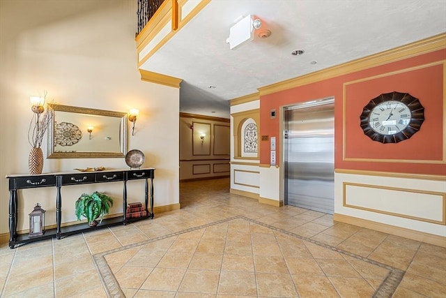 interior space with light tile patterned flooring, ornamental molding, and elevator