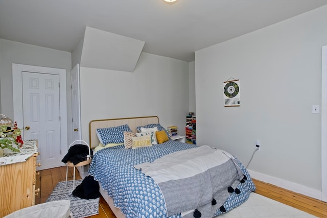 bedroom with hardwood / wood-style flooring