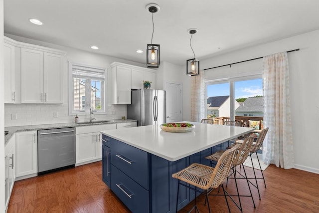 5 Redwood Path Unit 5, Hopkinton, MA 01748 - kitchen with appliances with stainless steel finishes, a sink, white cabinets, a breakfast bar area, and light countertops