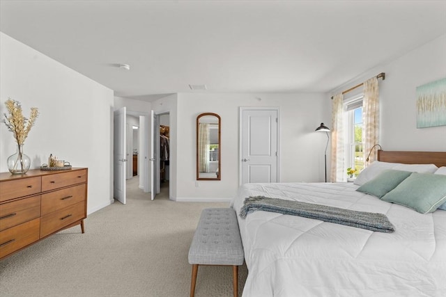 5 Redwood Path Unit 5, Hopkinton, MA 01748 - bedroom with light colored carpet, a walk in closet, and baseboards