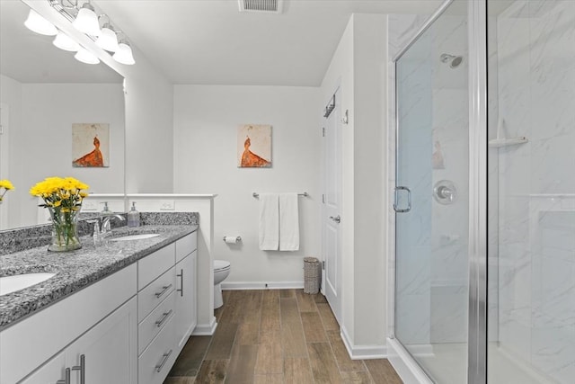 5 Redwood Path Unit 5, Hopkinton, MA 01748 - bathroom with wood finished floors, double vanity, toilet, a marble finish shower, and baseboards