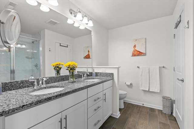 5 Redwood Path Unit 5, Hopkinton, MA 01748 - bathroom featuring double vanity, a stall shower, toilet, wood finished floors, and baseboards