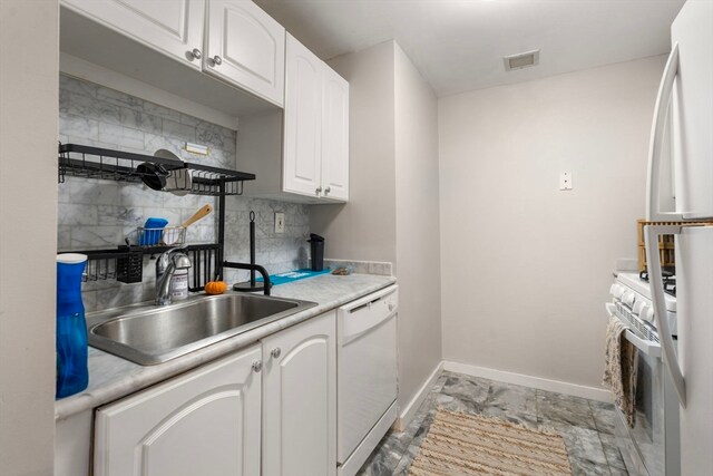 kitchen featuring white appliances, decorative backsplash, sink, and white cabinets