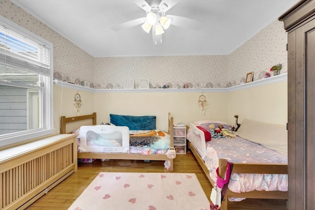 16 Highland Ave, Holden, MA 01520 - bedroom featuring wallpapered walls, wood finished floors, radiator heating unit, a ceiling fan, and crown molding