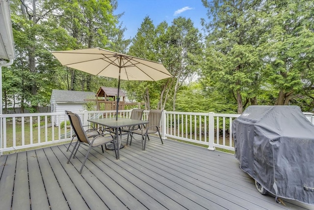 16 Highland Ave, Holden, MA 01520 - wooden deck featuring outdoor dining area, grilling area, and view of scattered trees
