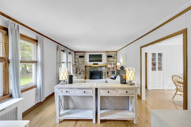 16 Highland Ave, Holden, MA 01520 - living area with a stone fireplace, crown molding, light wood finished floors, and baseboards