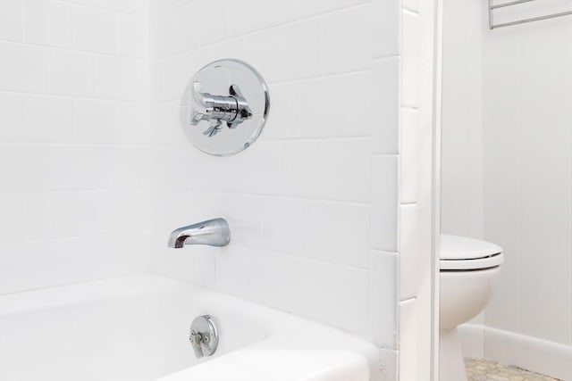 bathroom with toilet, a washtub, and walk in shower