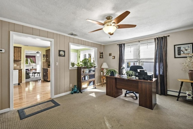 office featuring a ceiling fan, ornamental molding, carpet, baseboards, and a textured ceiling