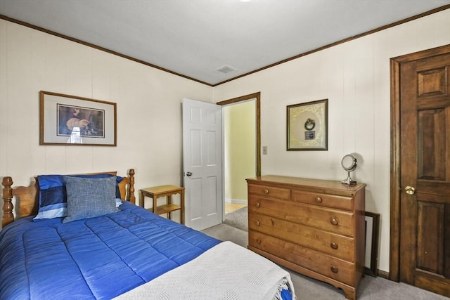 carpeted bedroom with ornamental molding and baseboards