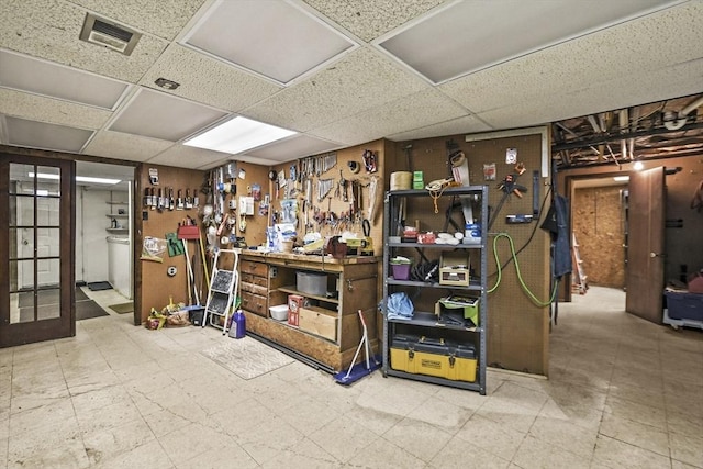 finished below grade area featuring a drop ceiling and tile patterned floors