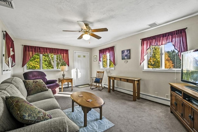 carpeted living area with baseboard heating, a ceiling fan, a textured ceiling, and baseboards