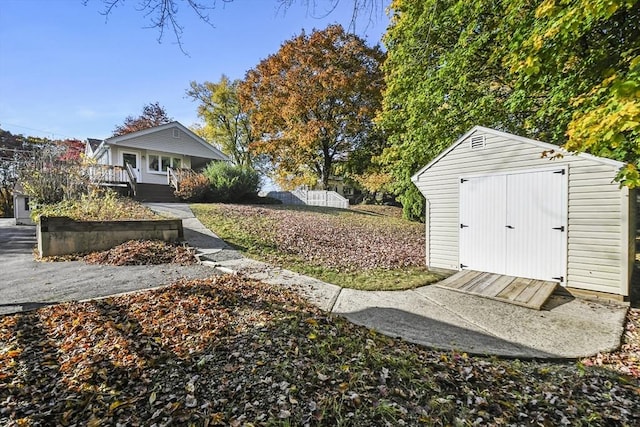 view of yard with a storage shed, an outbuilding, and a porch