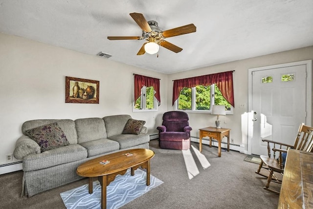 carpeted living area with baseboard heating and ceiling fan
