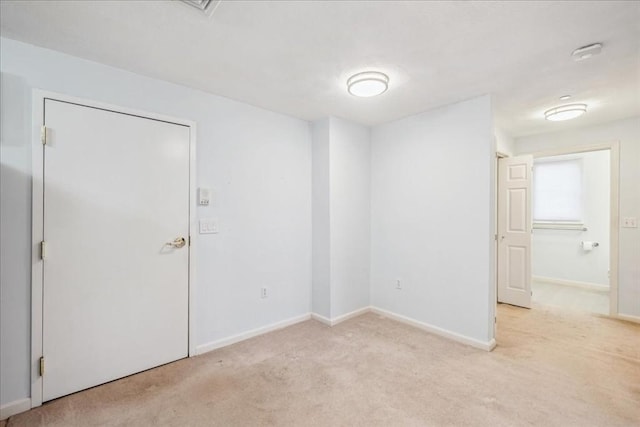 spare room with light carpet