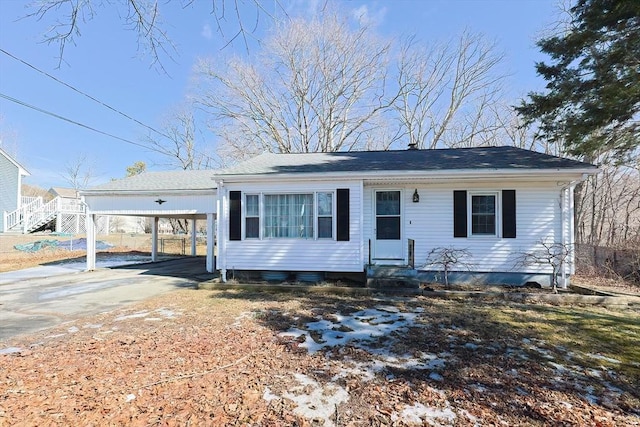 view of front of house with driveway, a carport, and entry steps