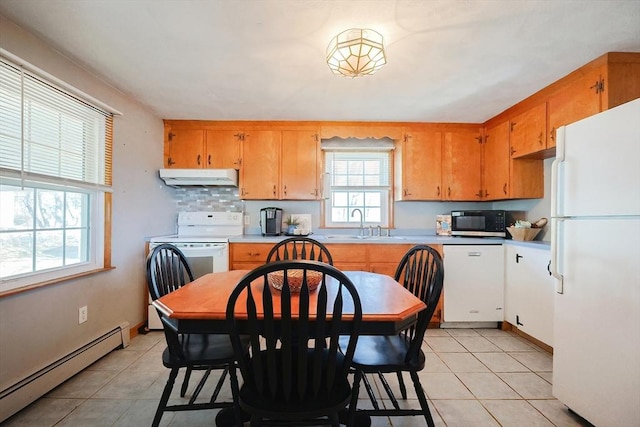 kitchen with white appliances, light tile patterned floors, under cabinet range hood, and baseboard heating