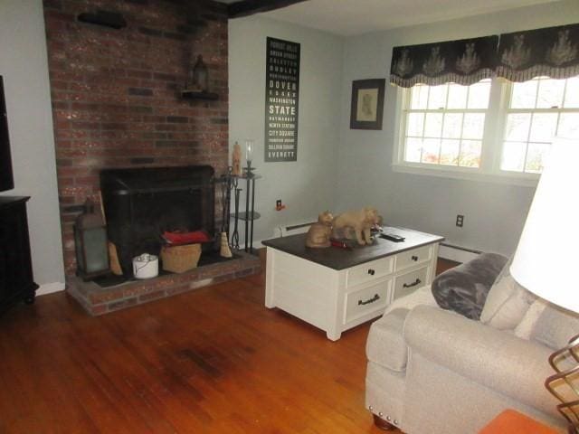living area with wood finished floors and baseboard heating