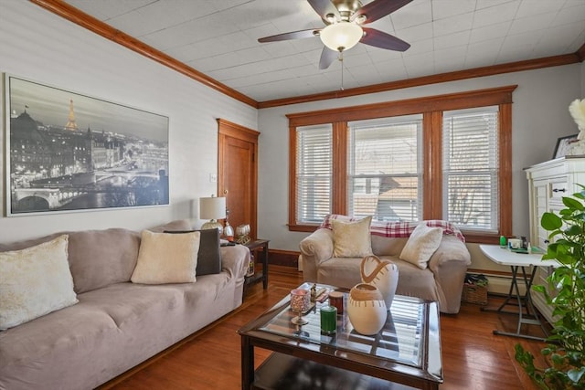 living room with baseboards, ceiling fan, ornamental molding, baseboard heating, and wood finished floors