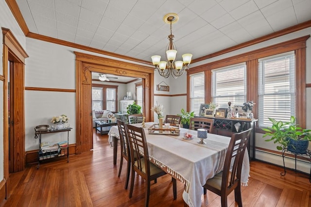 dining room featuring a chandelier, crown molding, and wood-type flooring