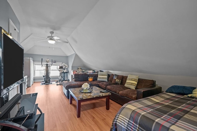 bedroom featuring ceiling fan, lofted ceiling, and light wood-style flooring