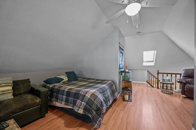 bedroom featuring vaulted ceiling, wood finished floors, baseboards, and ceiling fan