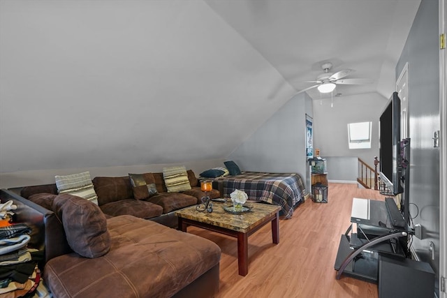 bedroom featuring vaulted ceiling, a ceiling fan, and light wood-type flooring