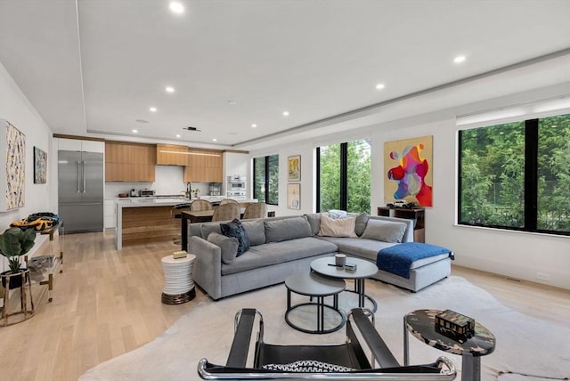 1242 Beacon St, Newton, MA 02468 - living area with healthy amount of natural light, light wood finished floors, recessed lighting, and a tray ceiling