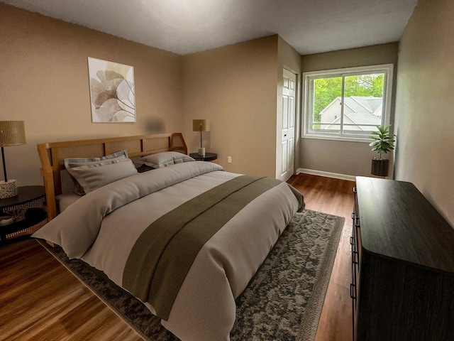 bedroom featuring wood finished floors and baseboards