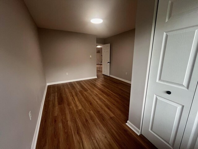 unfurnished room featuring dark wood finished floors and baseboards