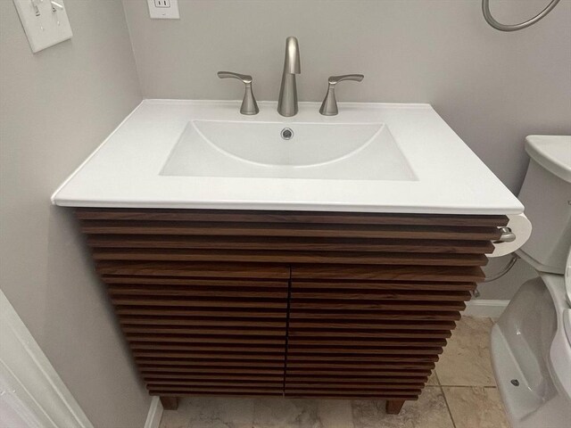 bathroom with toilet and vanity
