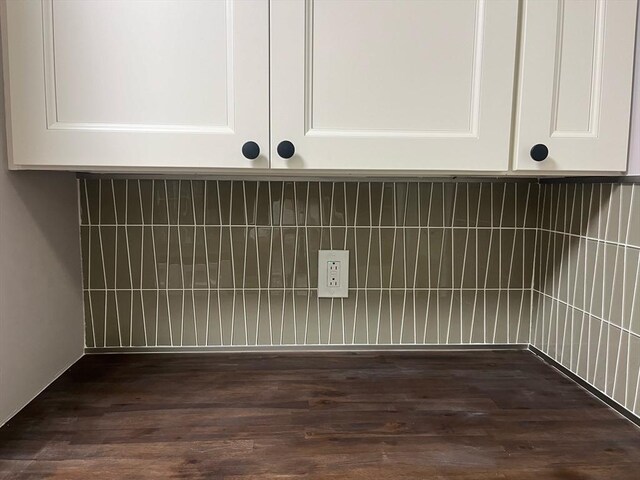 clothes washing area featuring wood finished floors