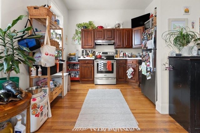1750 Washington St Unit 2, Boston, MA 02118 - kitchen with stainless steel appliances, under cabinet range hood, light countertops, and light wood-style flooring