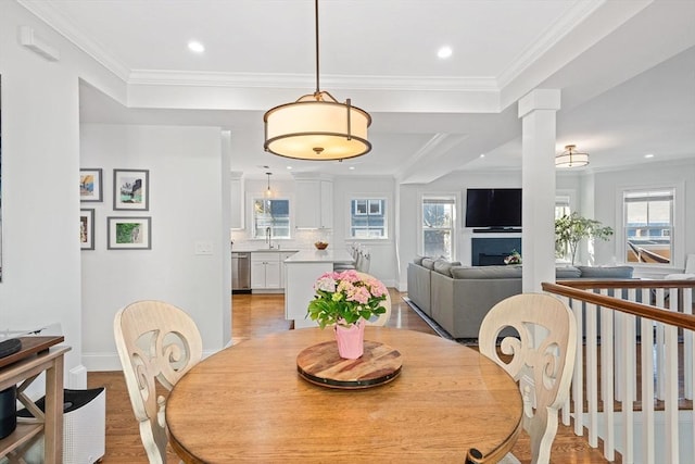 dining area with baseboards, a wealth of natural light, and light wood-style flooring