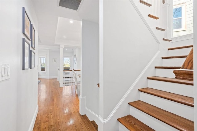 stairs featuring visible vents, recessed lighting, baseboards, and wood finished floors