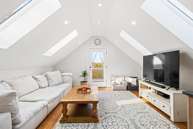 living area featuring recessed lighting, wood finished floors, and vaulted ceiling with skylight
