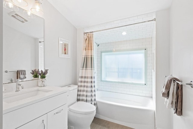 bathroom featuring visible vents, vanity, wood finished floors, toilet, and shower / bathtub combination with curtain