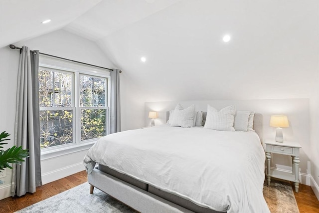 bedroom with recessed lighting, baseboards, wood finished floors, and lofted ceiling