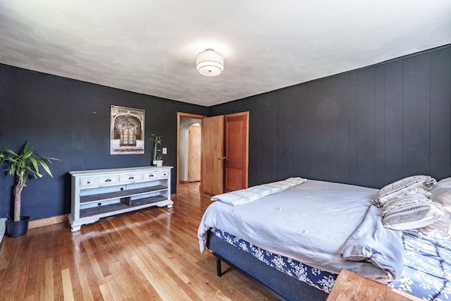 bedroom featuring baseboards and hardwood / wood-style flooring