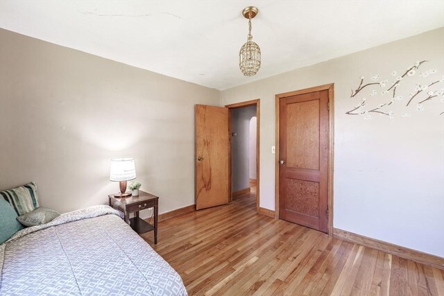 bedroom featuring baseboards and light wood-style flooring
