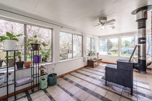 sunroom featuring baseboards and a wealth of natural light