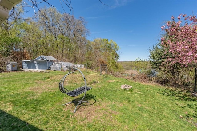 view of yard featuring a storage shed and an outdoor structure