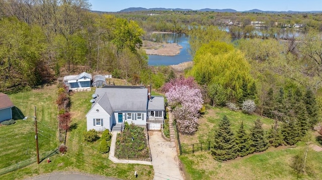 drone / aerial view with a water view and a forest view