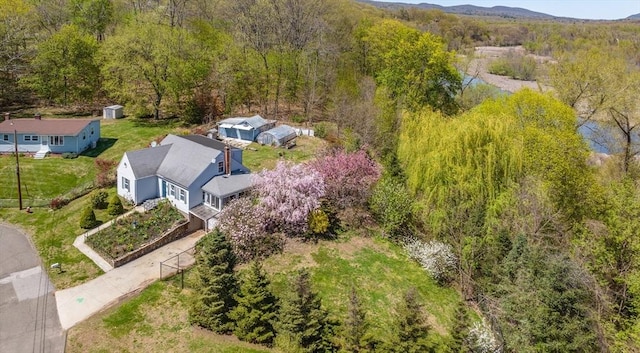 birds eye view of property with a wooded view