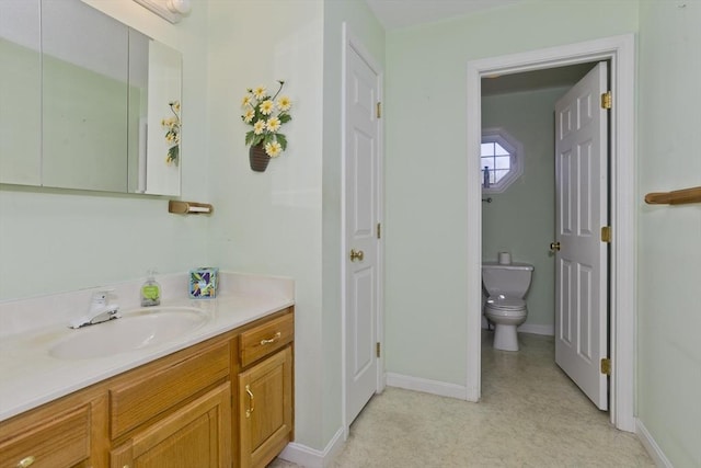 585 Sheridan St Unit 36, Chicopee, MA 01020 - bathroom featuring toilet, vanity, and baseboards