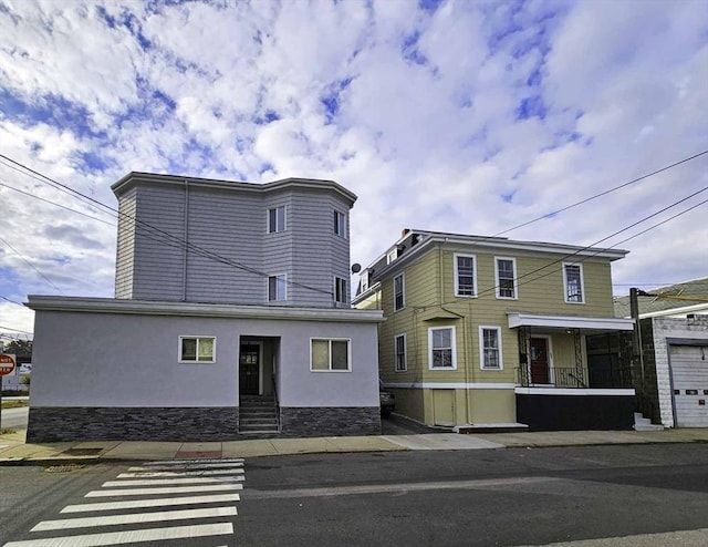 52-54 Bonair St, Somerville, MA 02145 - view of front of home featuring stucco siding and stone siding