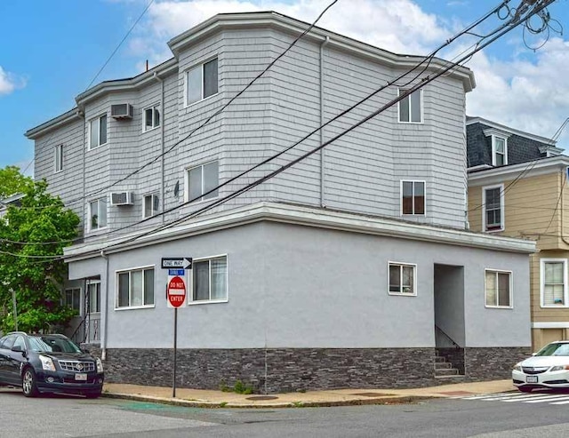 52-54 Bonair St, Somerville, MA 02145 - view of property exterior featuring stucco siding and stone siding