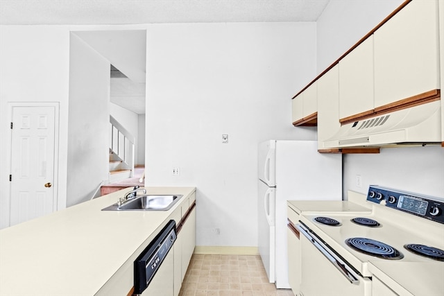 kitchen with range hood, white cabinetry, white appliances, and sink