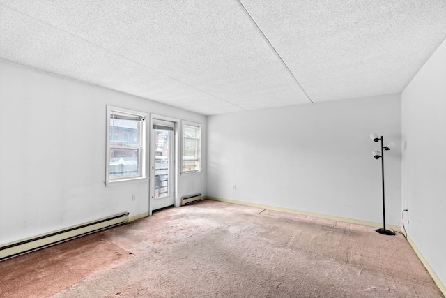 unfurnished room featuring baseboard heating, a textured ceiling, and carpet floors