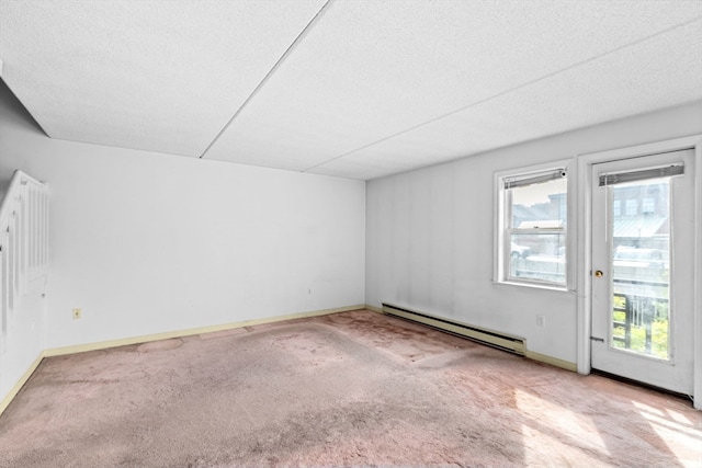 spare room featuring a textured ceiling, a healthy amount of sunlight, and a baseboard radiator